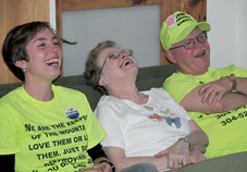 Larry Gibson, his wife Carol, and Tricia Feeney laugh at one of the speakers during the Earth Day fundraising event