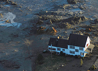 A house is surrounded with toxic coal ash after the 2008 TVA disaster.