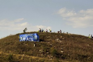 Activists plant trees on reclamation site while others hold banner reading "Reclmation FAIL." (Credit: Climate Ground Zero)