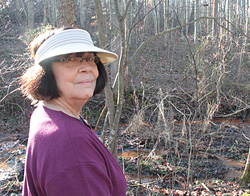 Kathy Selvage surveys orange water near her Virginia home.