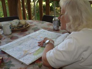 With a map of the Cumberland Gap spread on the table, Sylvia Ray, mother of Tammy Stachowicz, researches the residences of her Melungeon ancestors.