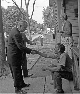 During his official poverty tour in 1964, President Lyndon B. Johnson shook the hand of a resident in an undisclosed part of Appalachia. Photo courtesy LBJ Library, by Cecil Stoughton