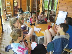 Interns at the New Beginnings camp meet in the afternoons to plan for upcoming days and discuss how to resolve conflicts between campers. Photo by Kimber Ray