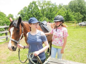 "It's about more than riding, that's for sure," explains Nancy Williams, an instructor for the "connected riding" horse class at High Rocks, where the girls learn to be aware of body language. "If we can't get the lesson through verbally, the horses do it in a non-verbal way." Photo by Molly Moore