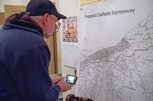 A resident looks at a map of the proposed Coalfields Expressway during a community forum. Photo by Alistair Burke, alistairburkephotography.com