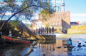 Guilford College students in front of the retired Dan River Steam Station during a river outing with the Dan River Basin Association in 2013. The association has long promoted citizen water quality testing as a vital component of healthy waterways. Photo by Brian Williams