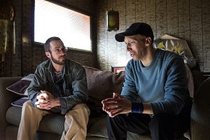 In his home, Zach Dixon, right, talks with Rory McIlmoil of Appalachian Voices about his high heating bills. Photo by Jaimie McGirt