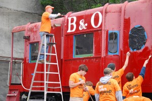 Community members participating in the Grafton, W. Va., Turn This Town Around initiative completed projects such as repainting a downtown caboose. Photo courtesy of Amanda Yager, WV Community Development Hub
