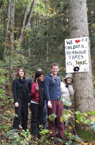 Park University students post signs at Cranks Creek Lake in Kentucky, warning about the hazards of burning tires. Photo by Dave Cooper