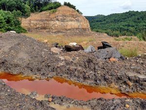 Acid mine drainage collects at the KD #2 mine site shortly after the state halted work at the mine. A recent inspection recorded pH values between 3 and 4, which is 100 to 1,000 times more acidic than allowed by law. Photo courtesy the Kanawha Forest Coalition