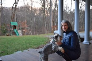Jill Averitt and her dog, Cliff, enjoy a moment outdoors. The Atlantic Coast Pipeline would cut through her land, along the hillside just beyond the swing set. Photo by Cat McCue