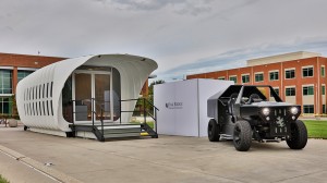 The 3D-printed home and vehicle sit on display at Oak Ridge National Laboratory in East Tennessee. 