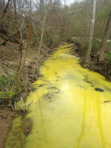 A creek in Martin County, Ky., ran bright yellow in April. The state claimed that yellow highway-marking paint was to blame. Photo via Facebook