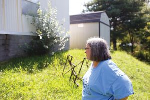 Left, Gerlene Wilmoth surveys the damage to the foundation of their home in Tazewell, Tenn. Photo by Lou Murrey. 