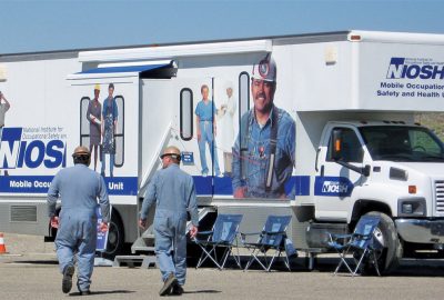 Miners walk to a mobile health screening unit operated by the National Institute for Occupational Safety and Health. Photo courtesy of CDC-NIOSH