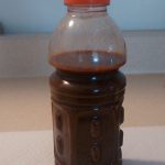 Plastic bottle with rust-colored tap water