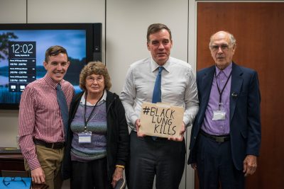 Big Stone Gap councilman Tyler Hughes, Peggy Brock from the SWVA chapter of the Black Lung Association and Bethel Brock, president of the SWVA chapter of the Black Lung Association and a former miner living with complicated black lung disease, met with Senator Mark Warner (second from right) to hand-deliver four local resolutions of support for extending the black lung excise tax.
