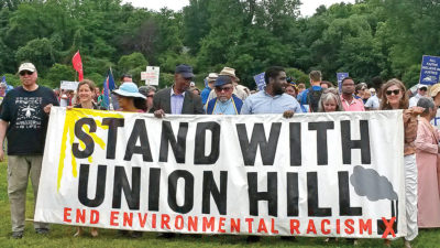 Protestors hold banner that reads, "Stand with union hill"