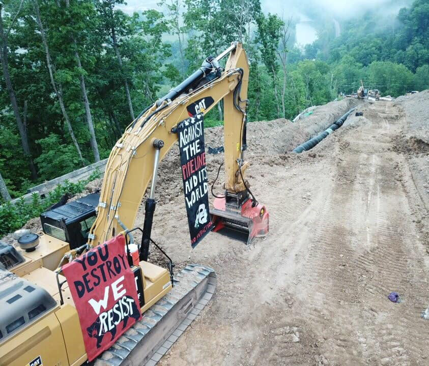 Protest banners hanging on pipeline equipment