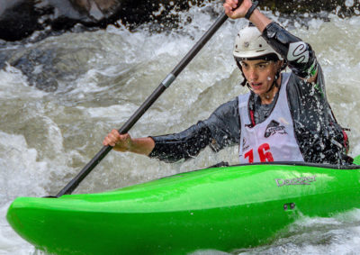 Kayaker paddles through rapid