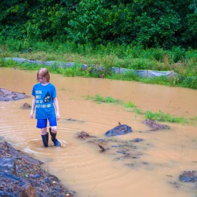 child in muddy water