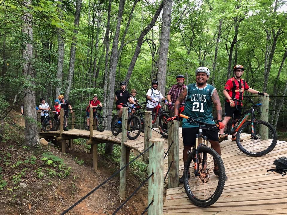 Group of riders paused on wooden ramp