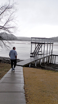 Gary Topmiller walks to the dock of his former dream home where the waters have been contaminated by toxic pollutants from the coal ash spill. Photo by Maureen Halsema.
