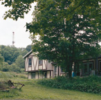 As the natural gas boom continues, states are facing regulatory challenges to protect private landowners. In Dimock, Pa. — a town transformed by hydraulic fracturing in the Marcellus Shale — a drilling rig looms over a nearby home. Photo by Aaron Nutter.