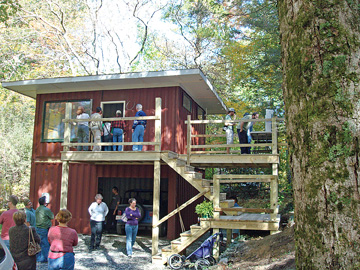 Tour participants inspect a small container house in Boone, NC . The house’s frame is constructed by stacking two metal shipping containers. When this photo was taken, the garage/apartment had been under construction for only 20 days.