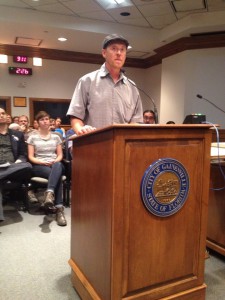 Gainesville Loves Mountains founder, Jason Fults, advocates for a policy discouraging the purchase of mountaintop removal coal before the Gainesville City Commission on Sept. 18