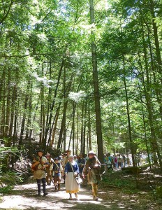 At Cumberland Gap National Historical Park, reenactors commemorate the first crossing of the gap by European settlers in 1775. The trail marker denotes the beginning of the Boone Trace pathway at the park. Sam Compton, president of The Boone Society, notes that a gap in the trees seems to form a heart above Daniel Boone. Photo by Roberta Mills, Boone Society