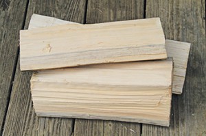 Split wood dries faster.  No wider than six  inches is what the EPA recommends.