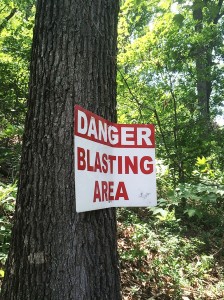 Numerous signs warning of blasting, put up by the company, are located throughout the Johnson family’s property. Photo by Tarence Ray  