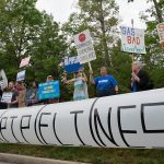people stand with "no pipelines" signs