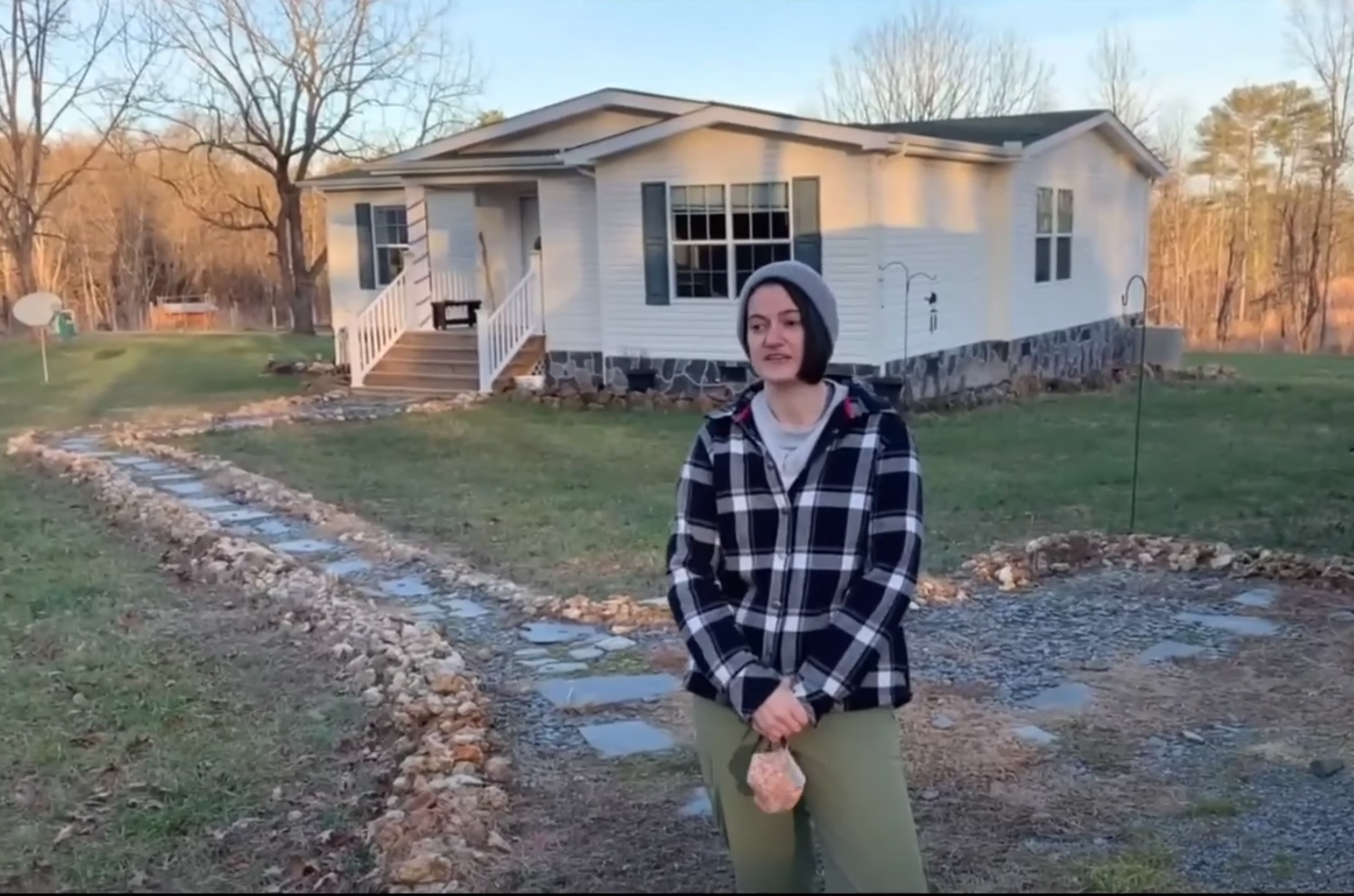 Stephanie Rinaldi in front of white ranch house