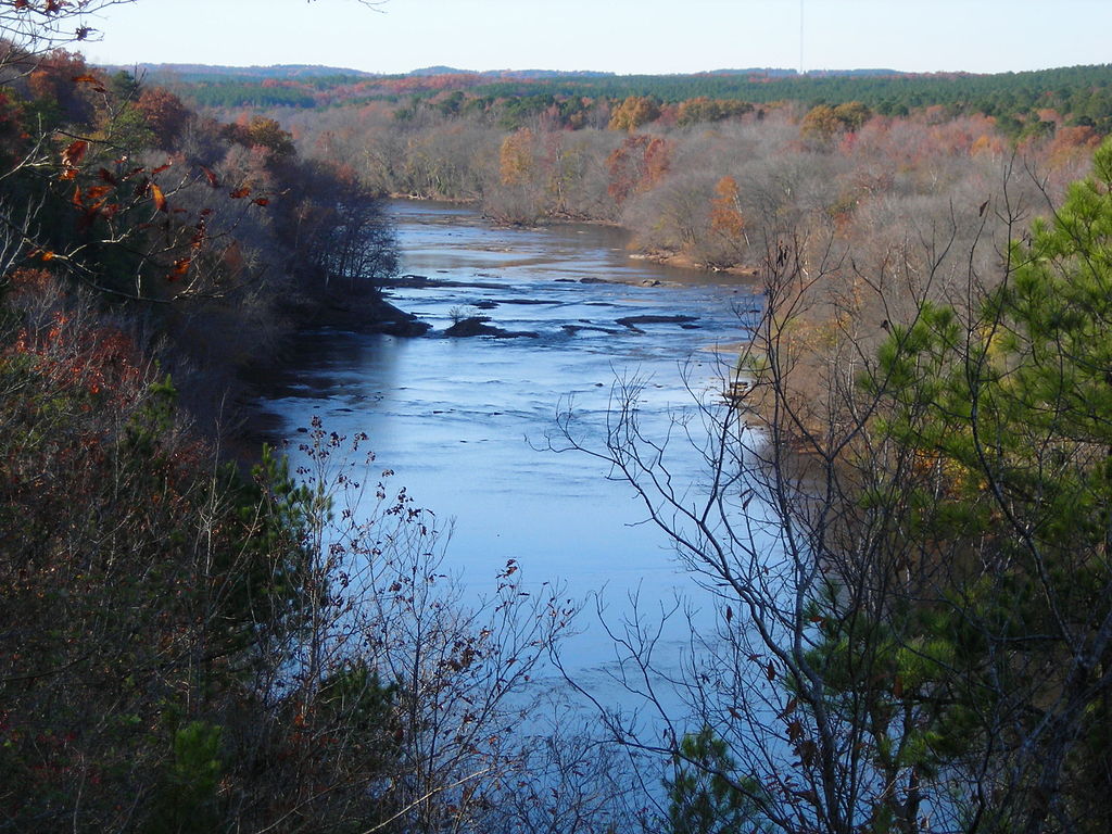 wide blue river flanked by autumn trees