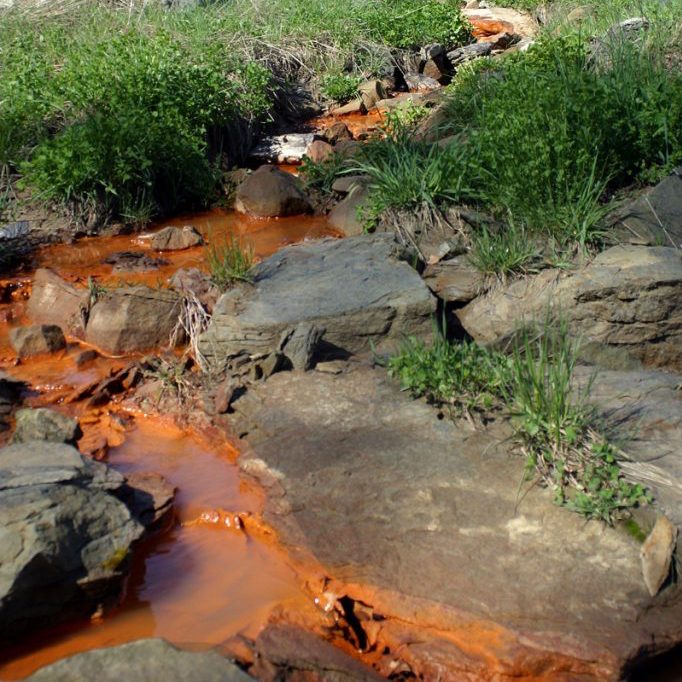 Photo of orange acid mine drainage from a Kentucky surface mine by Matt Wasson