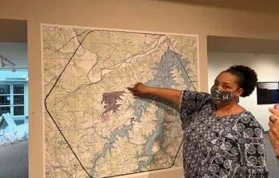 Woman points to location on a map.