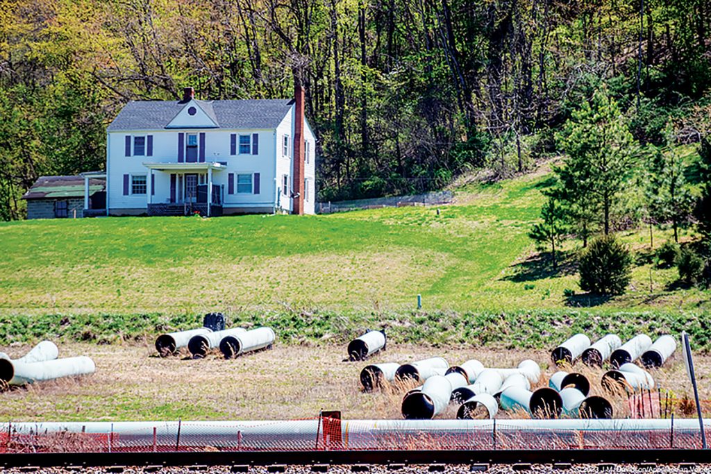 Mountain Valley Pipeline pipes litter the ground along the pipeline in front of a Virginia home.