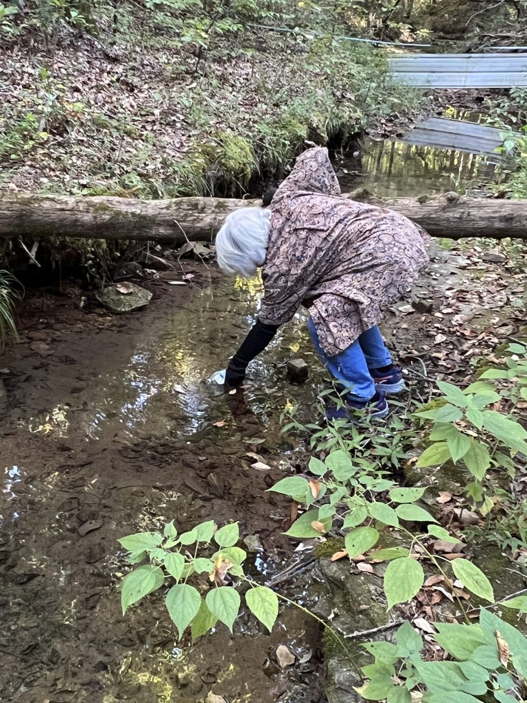 A Cumberland Preservation Group member samples water from one of the springs on her property.