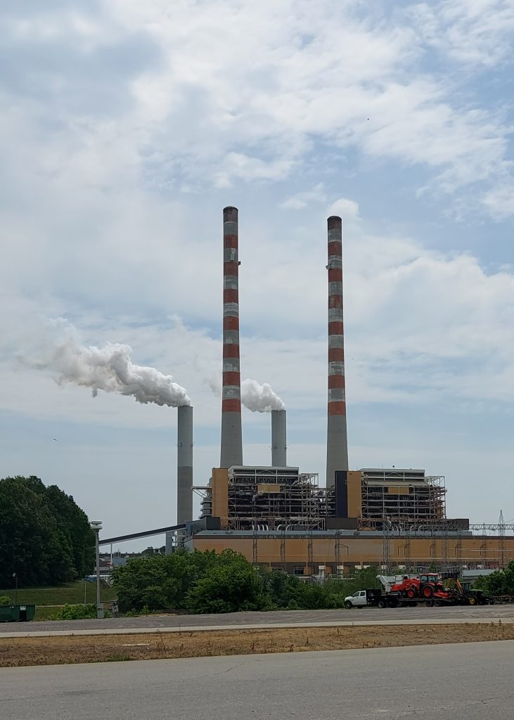 Smoke drifts out of stacks on a powerplant.