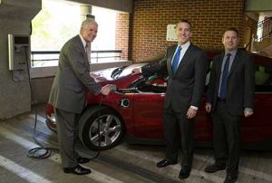 At a parking garage on the University of Virginia campus in Charlottesville, the university's associate dean of students plugs in a Chevy Volt. Photo by Dan Addison