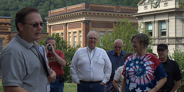 Doug Estepp, left, discusses the assassination of Sid Hatfield with a tour group. Photo by Klair Gaston 