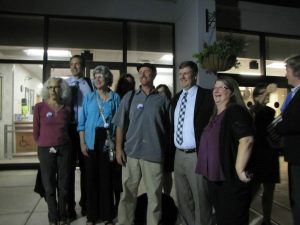 Members of Gainesville Loves Mountains and Appalachian Voices' staff celebrate with commissioner Lauren Poe after the vote. 