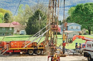 The minimum required distance between gas wells and homes allows for construction at close quarters with neighboring residents. Courtesy of Terry Wild Stock Photography.