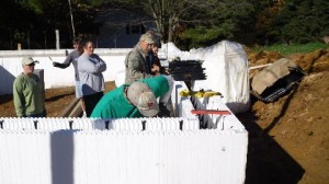 A group of volunteers for Ashe County Habitat for Humanity set foam blocks into place. Concrete will be poured over the blocks to create an airtight wall.