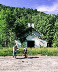 Photographer Brady Darragh and activist Chuck Nelson stand outside the abandoned union hall in Lindytown, W.Va. Lindytown's population, like that of Coalville, was displaced by the mining industry. 