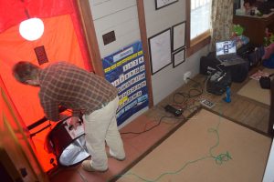 John Kidda, owner of reNew Home Inc., conducts a blower door test on the home of Blue Ridge Electric member Sean Dunlap. 