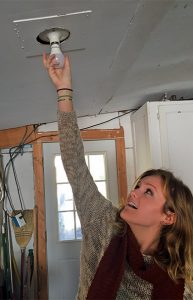 volunteer installing lightbulb