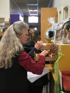 A woman looks through the seeds available in the Watauga Public Library's former card catalog. Photo by Cody Miller 